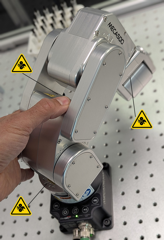 (a) pinching between some adjacent robot links